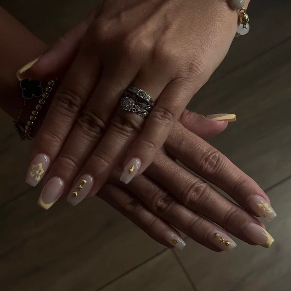 Nude nails with gold floral charms